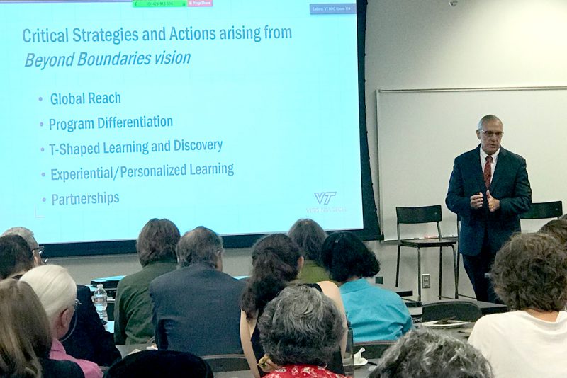 Executive Vice President and Provost Cyril Clarke talks to faculty and staff at the Northern Virginia Center in Falls Church on Thursday. 