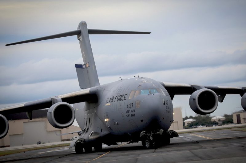 A U.S. Air Force C-17 Globemaster lands on a runway.