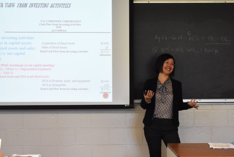 Finance associate professor Jin Xu teaches a class in corporate finance in Pamplin Hall.
