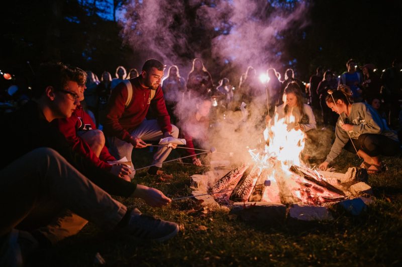 Students roast marshmallows at the Homecoming Campfire Kickoff.