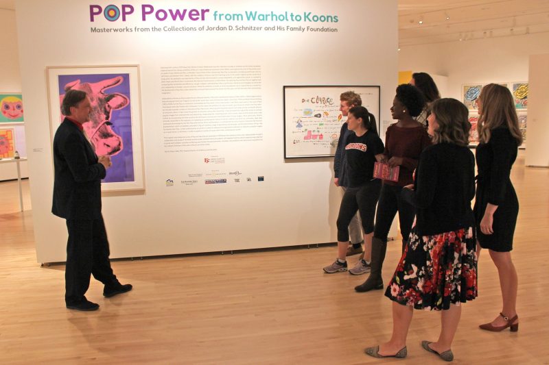 A group of visitors tour the POP Power exhibition at the Taubman Museum of Art. 