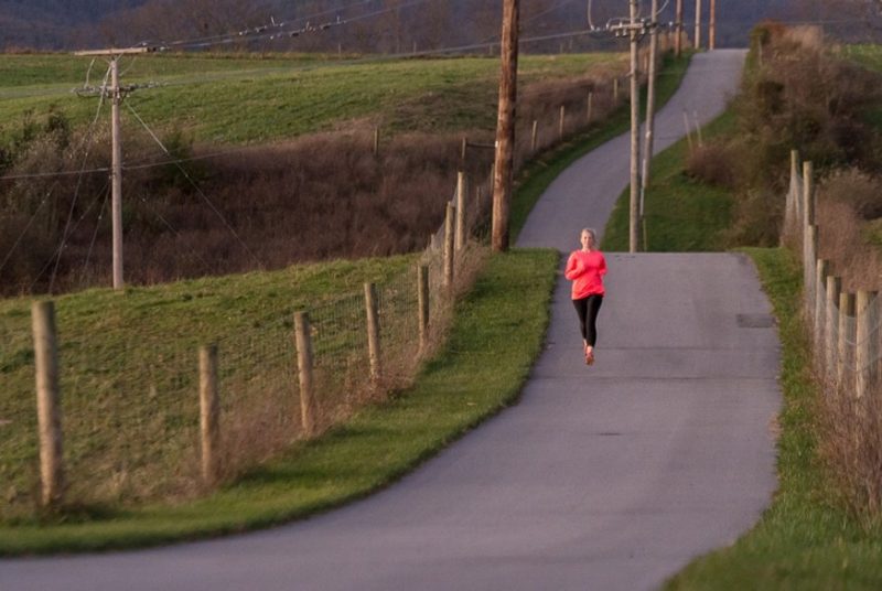 A woman runs on the Huckleberry Trail