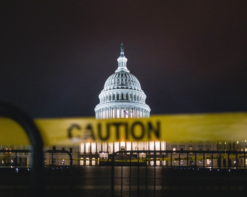 Image of US Capitol with "caution" tape in front 