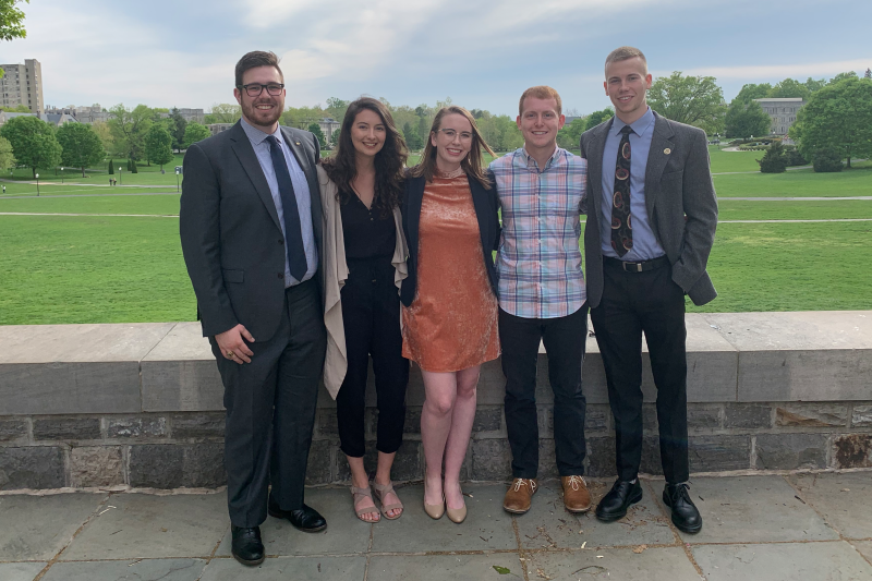 Members of  the 2018-2019 Student Government Association standing outside with greenery in the background. 