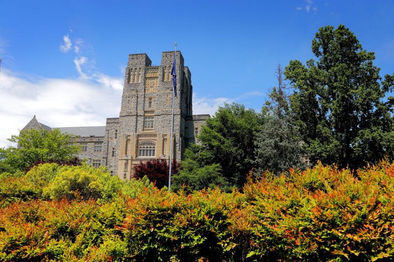 The front of Burruss Hall is seen against a blue sky