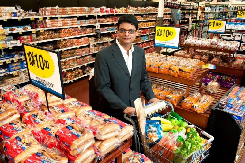 Rajesh Bagchi stands in a grocery store, surrounded by an array of food choices.