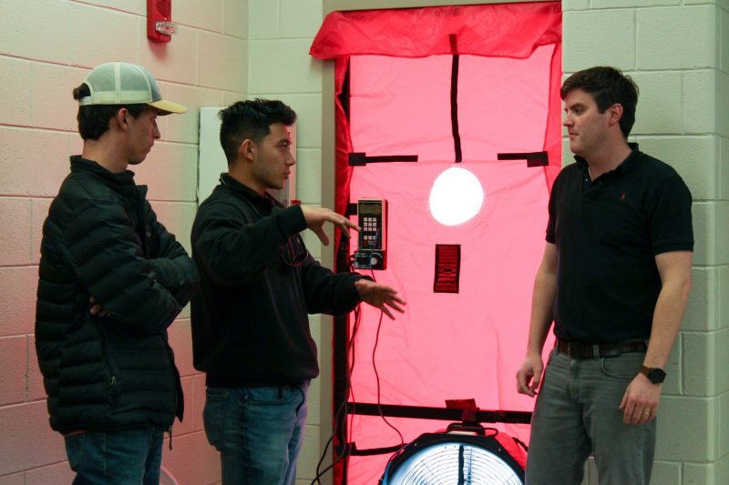 Students learn about Weatherization and the blower door from Assistant professor Philip Agee.