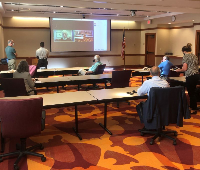 A group holds a hybrid meeting, where some attendees are on-location while others join remotely, at The Inn at Virginia Tech and Skelton Conference Center