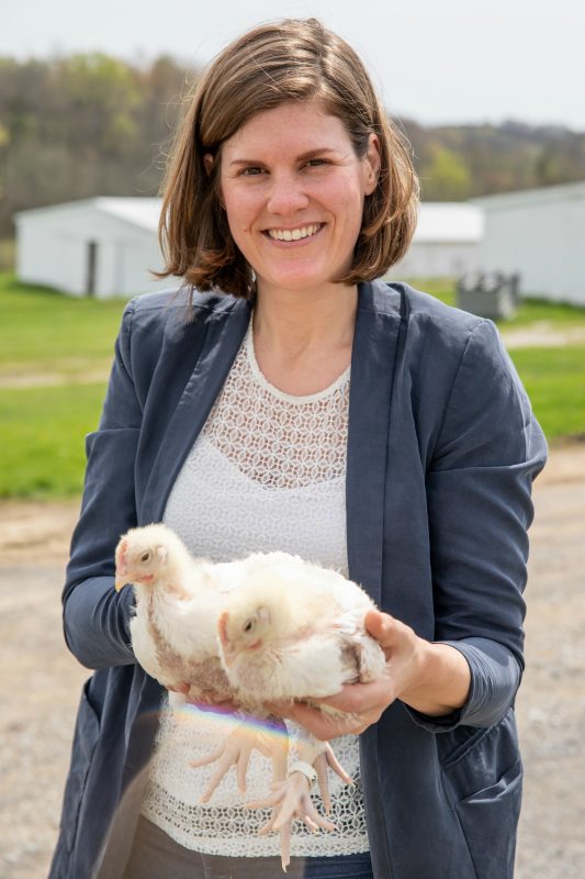 Image of Leonie Jacobs holding two chicks 