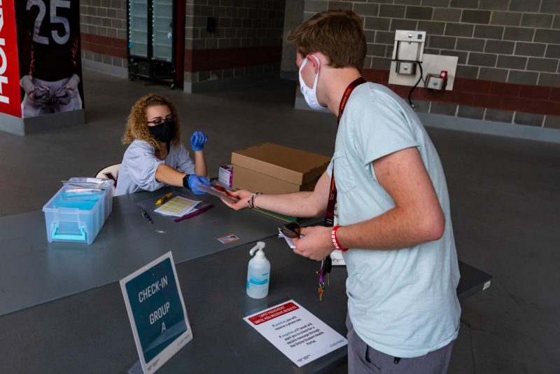 A student prepares for a COVID-19 test during move-in in August. 