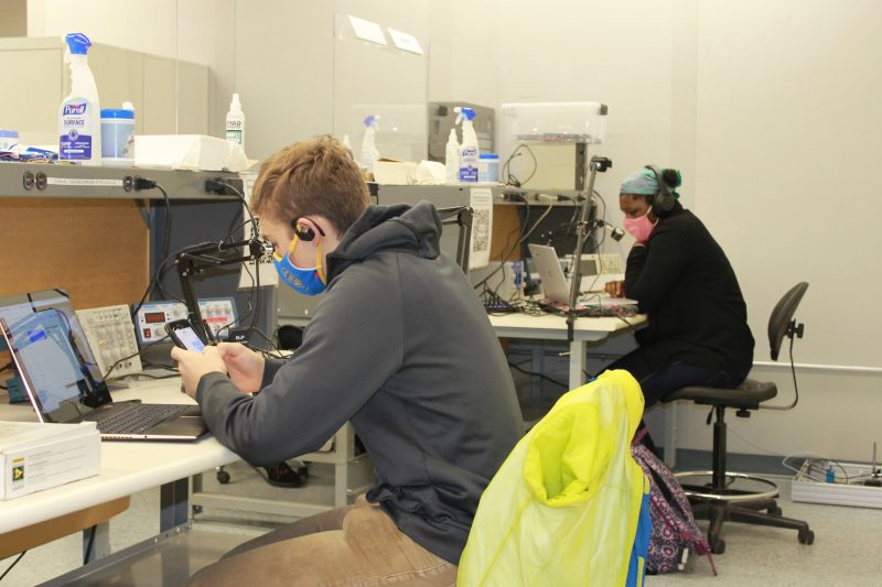 Students attending lab sessions in person interact with their teammates via Zoom. The experimenter has three cameras with views of the workbench, the instrumentation and the circuit board.