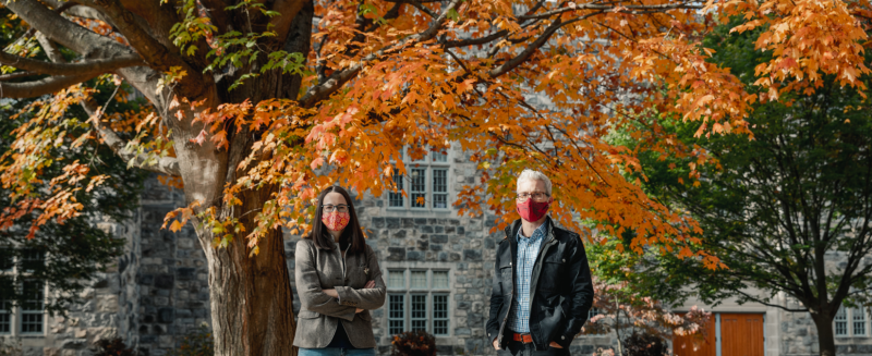 Anne Staples and Jake Socha, faculty members in biomedical engineering and mechanics, standing in front of fall foliage on Virginia Tech campus. Photo by Spencer Roberts of Virginia Tech.