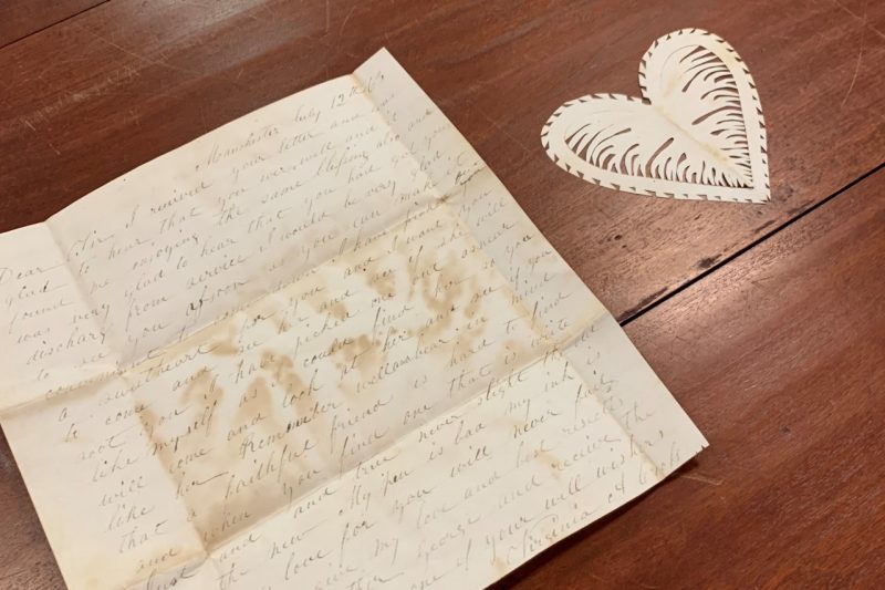 A hand written letter by Virginia Cross and a delicately cut paper heart.
