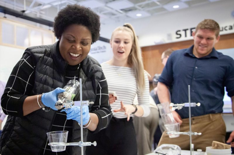 Brenda Brand (foreground), an associate professor of science education in the Virginia Tech School of Education, conducts a demonstration during a STEM fair for graduate students.