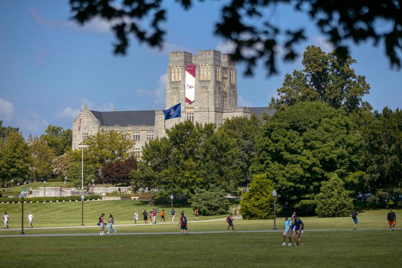 Burruss Hall draped in the 150 banner from the vantage of the Drillfield