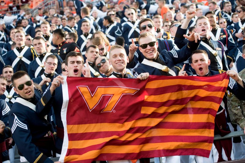 Cadets cheering at game with VT flag