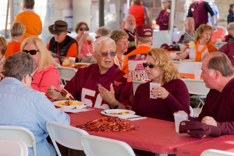 group of VT alumni eating at tailgate