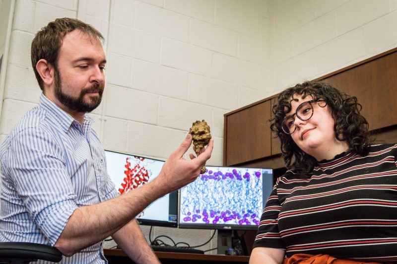 Justin Lemkul, Virginia Tech Biochemistry Assistant Professor, and Julia Montgomery, Virginia Tech Biochemistry Graduate Student, sit and look at 3D printed model of a protein
