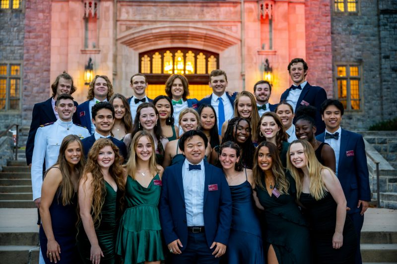 students in formal wear smiling outside Burruss Hall