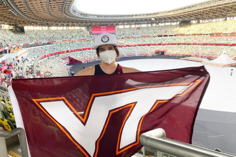 Kate Gest represented her alma mater with a Virginia Tech flag inside the Japan National Stadium prior to the start of the Tokyo Olympics.