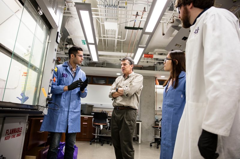 Photo of Northwestern University professor John Rogers and students in a laboratory 