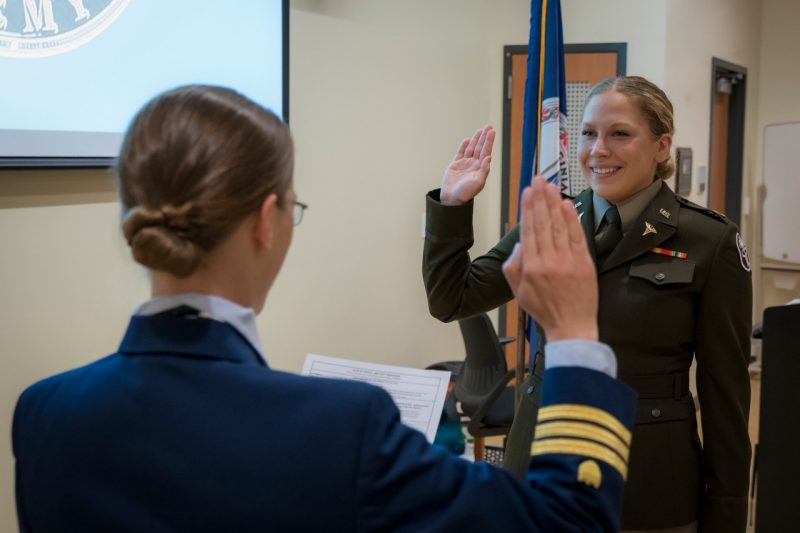 Dawn Wright Ullman raises her right hand and is sworn in as Captain in the U.S. Army by Cdr. Kristina Lewis of the U.S. Coast Guard.