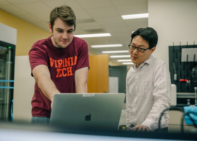 Vincent Wang, associate professor in biomedical engineering and mechanics, mentors a student researching in his lab. Photo by Spencer Roberts of Virginia Tech.
