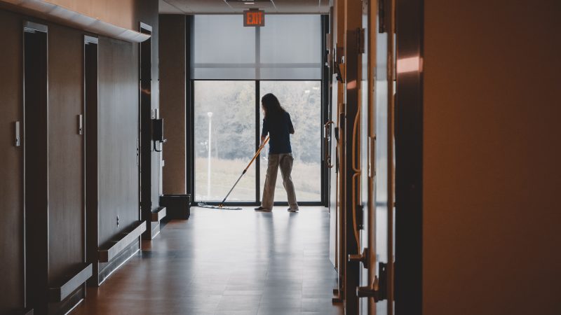 Housekeeper sweeping floor in the Human and Agricultural Biosciences Building One.