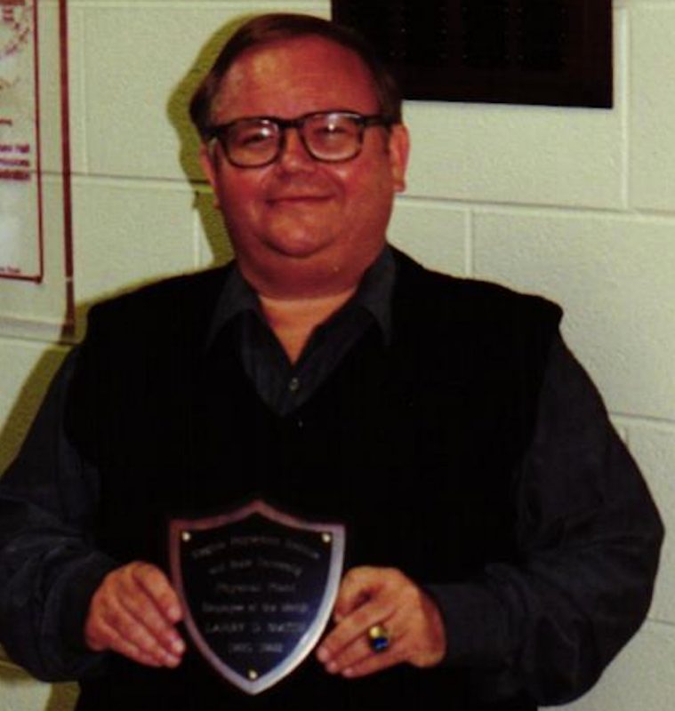 Larry Smith holding an award