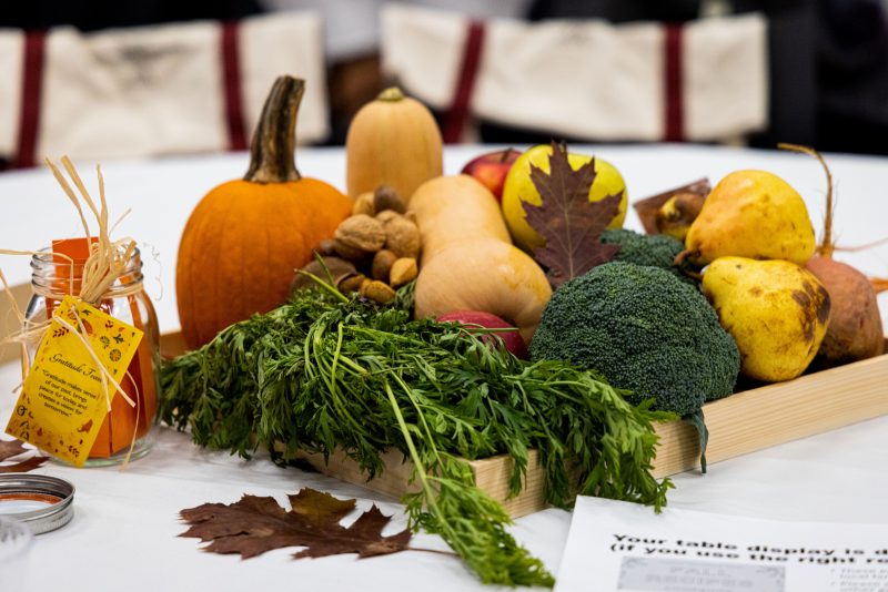 A fall harvest including pumpkin, squash, broccoli, nuts, apples, and pears form the tables' centerpiece at the Gratitude Feast.