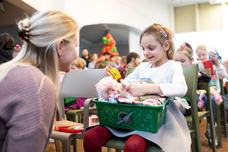 Natalya opening shoebox as part of Operation Christmas Child