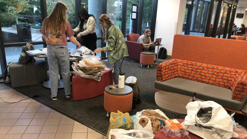 Students gather materials for recycling in Squires Student Center.