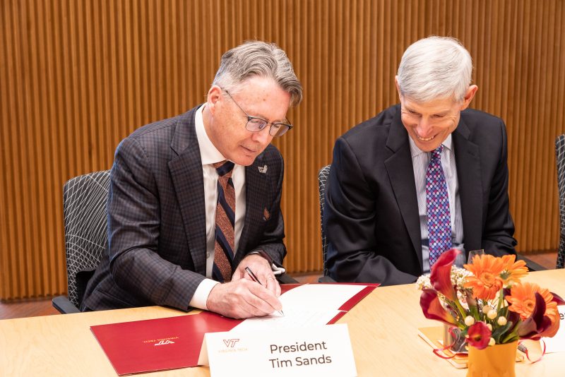 Virginia Tech President Tim Sands (at left) signs the memorandum of understanding with Institute for Defense Analyses President Norton A. Schwartz (at right).