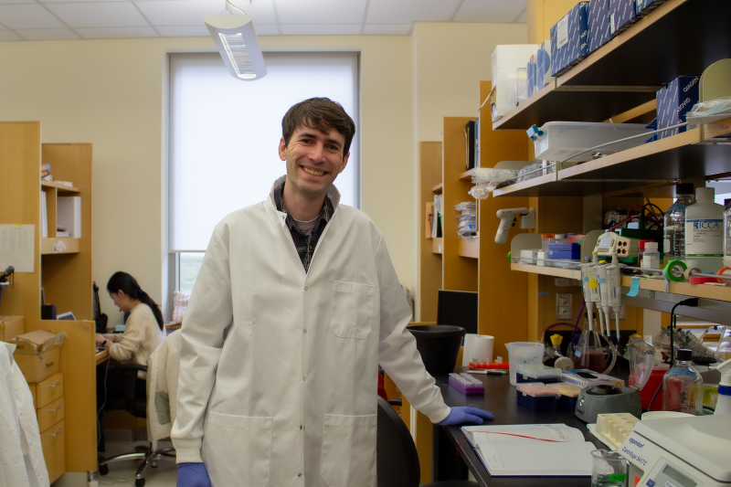 This image shows Blake Caldwell standing in the Li lab.