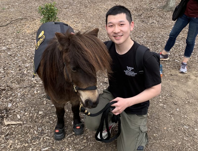 Zach Guo poses with Ringo the Patrol Pony