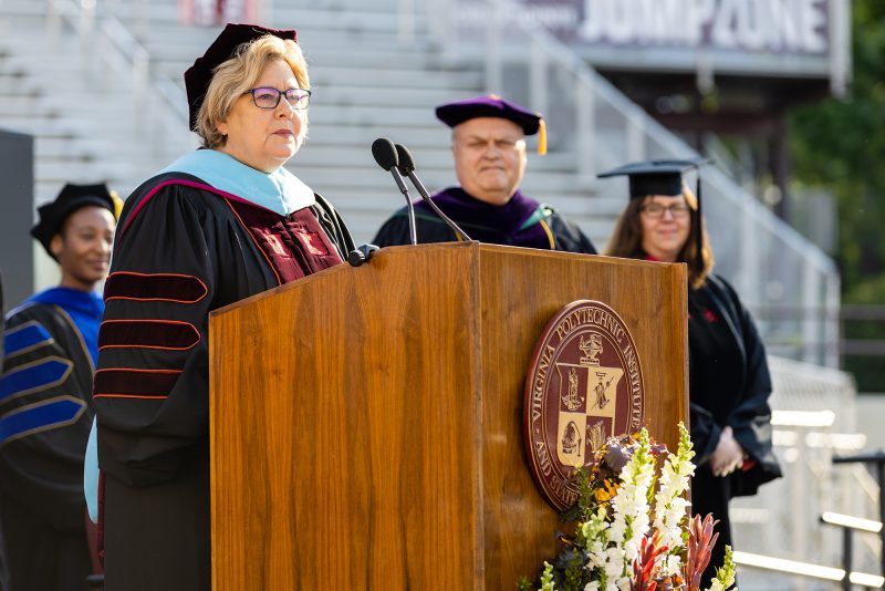 Roberta S. “Robin” Russell, pictured speaking at the 2023 spring commencement ceremony in her role as interim dean of Pamplin College of Business.